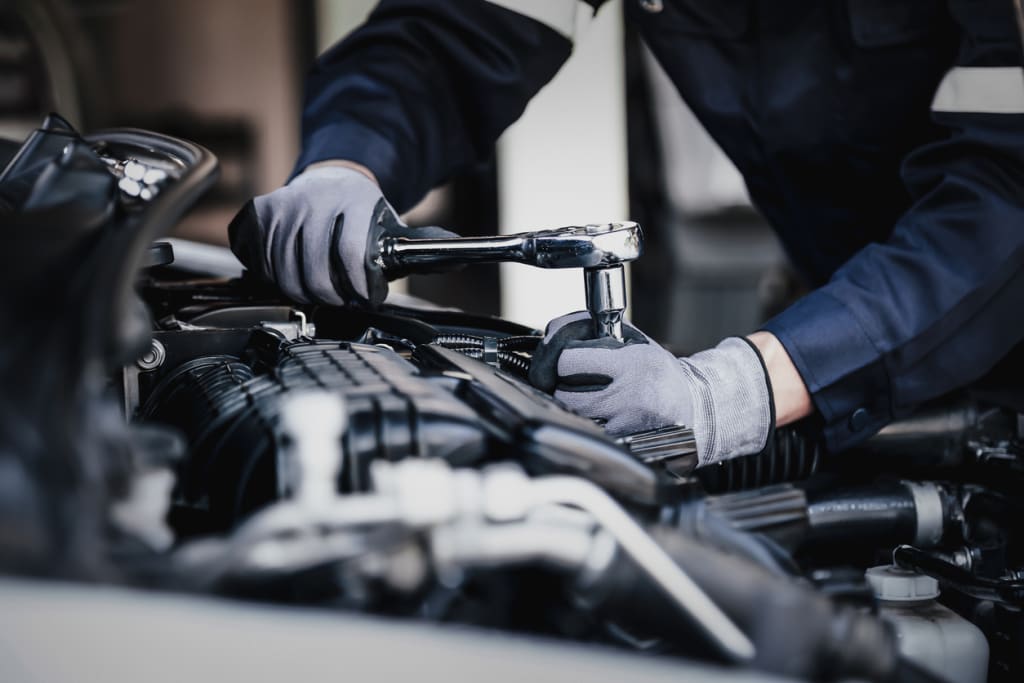 a mechanic working on an engine